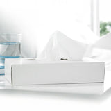 White tissue box on a white surface with a blurred background