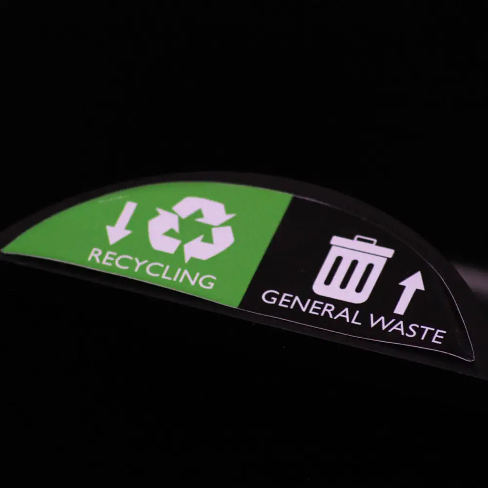 Recycling and general waste sign on a black background