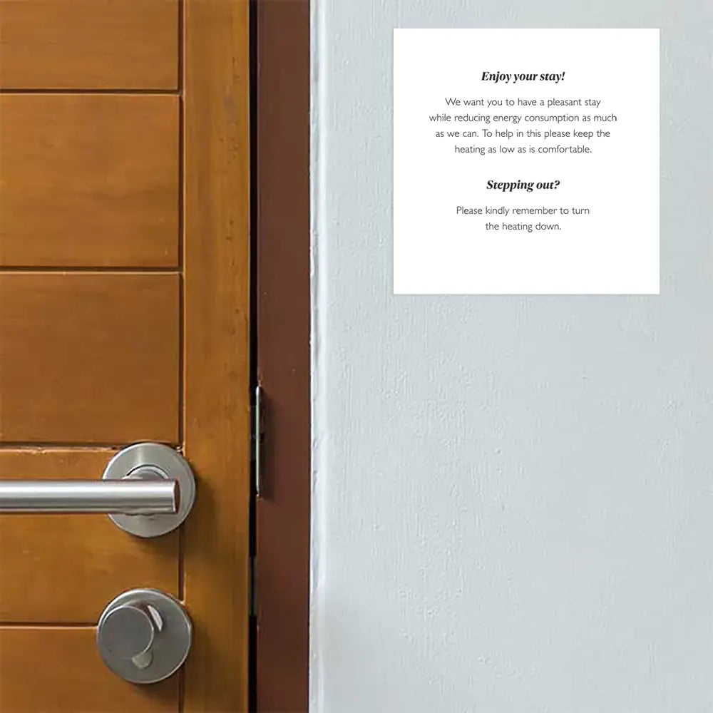 Wooden door with a Adhesive Energy Saving & Heating Notice on white ground on a gray wall