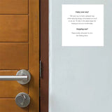 Wooden door with a Adhesive Energy Saving & Heating Notice on white ground on a gray wall