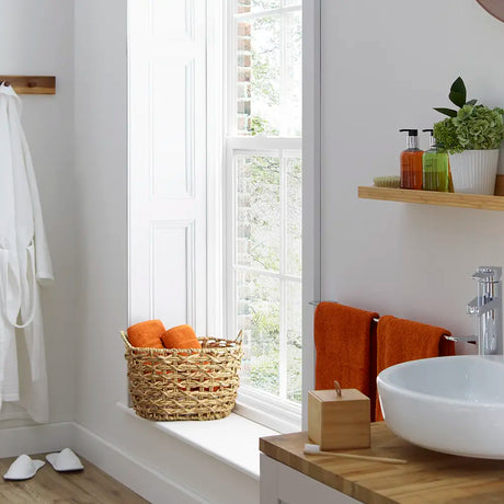  Bamboo container in lifestyle setting - Bathroom interior with a window, sink, and featuring items from Cole and Lewis lemongrass and bergamot range on a shelf.
