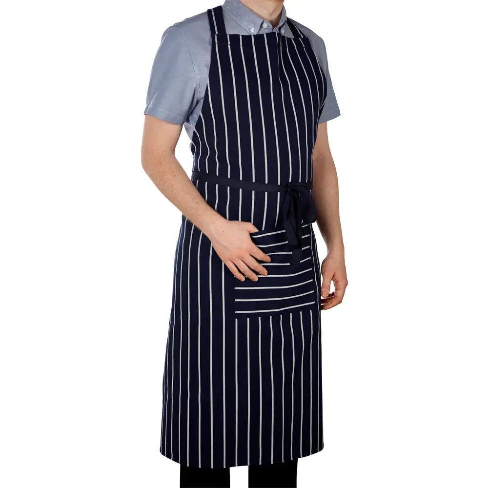 A person wearing a navy blue striped apron with a front pocket, standing against a white background.